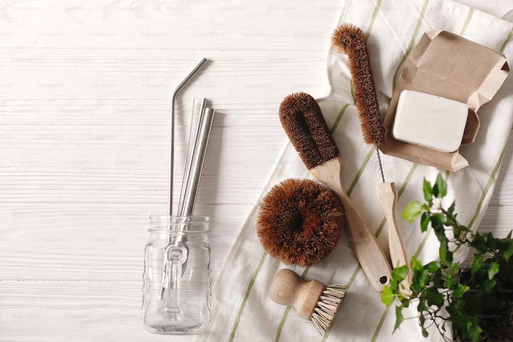 zero waste food cleaning. eco natural coconut soap and brushes for washing dishes, metal straws, eco friendly flat lay. sustainable lifestyle concept. plastic free items. reuse, reduce