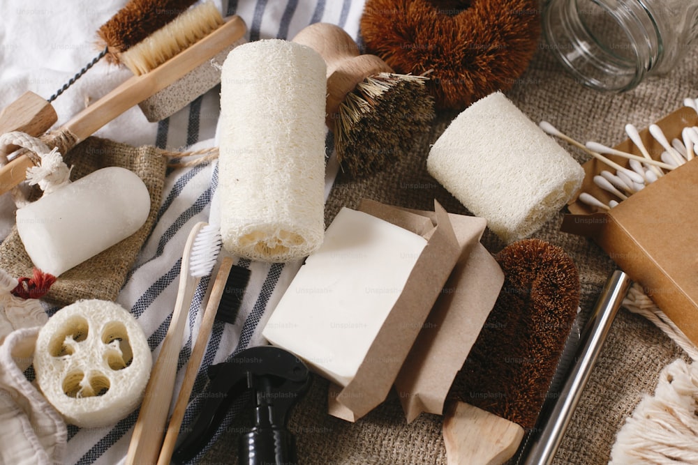 concetto di stile di vita sostenibile. Spazzolino da denti in bambù naturale eco, spazzola, deodorante di cristallo, luffa, bastoncini per le orecchie, cannucce di metallo, sapone al cocco, sacchetti di cotone, detersivo fatto a mano. zero sprechi