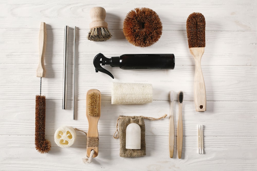 zero waste concept. natural bamboo toothbrush, brush, crystal deodorant,luffa,ear sticks, metal straws, handmade detergent for cleaning. eco flat lay. sustainable lifestyle