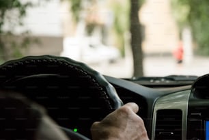 The driver is driving a car. Obtaining a driver's license, traffic rules The type of a city street through the windshield of a car