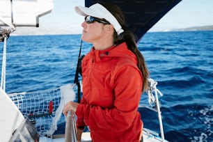 Attractive strong woman sailing with her sail boat