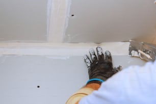 Hausverbesserungen. Putz an die Wand mit Spatel Handhaltendes Putzwerkzeug