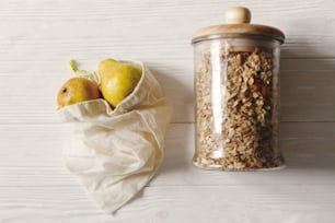 sustainable lifestyle concept. zero waste. eco natural bags with fruits and granola in glass, flat lay. plastic free items. reuse, reduce, recycle, refuse. bulk store
