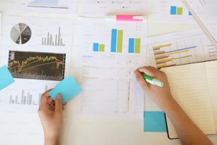 Top view hand working of business finance data with paper graph of financial.