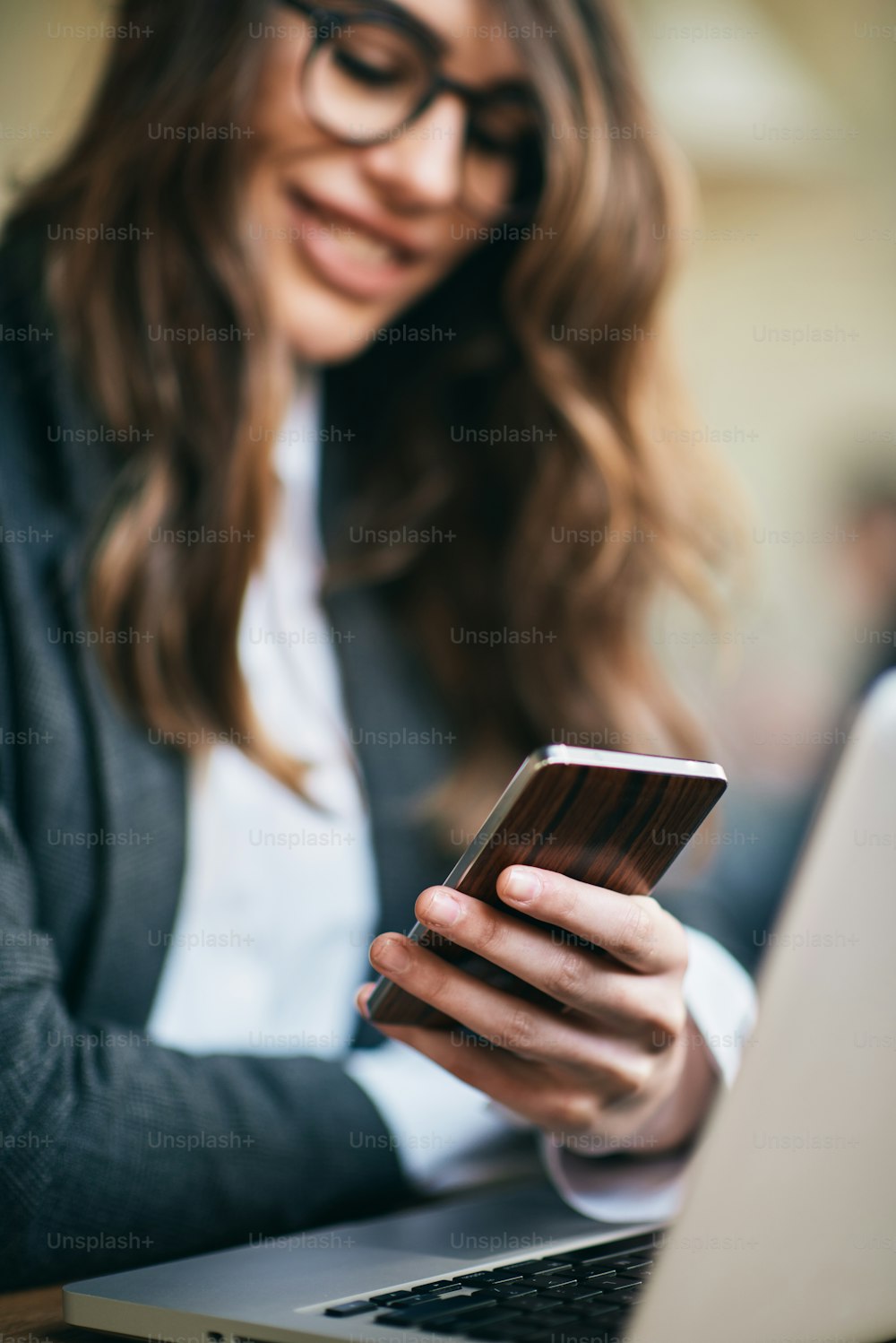 Young modern woman sitting in cafe and using smart phone.