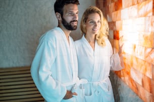 Attractive happy couple relaxing in spa center together
