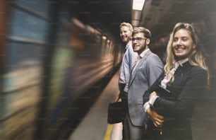 Business people waiting for transportation underground