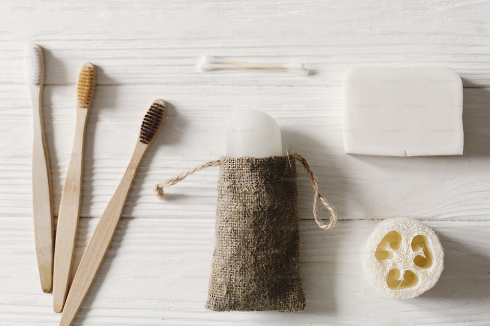 sustainable lifestyle concept. zero waste flat lay. bathroom essentials, plastic free items. eco natural bamboo toothbrush, crystal deodorant,luffa, coconut soap,ear sticks
