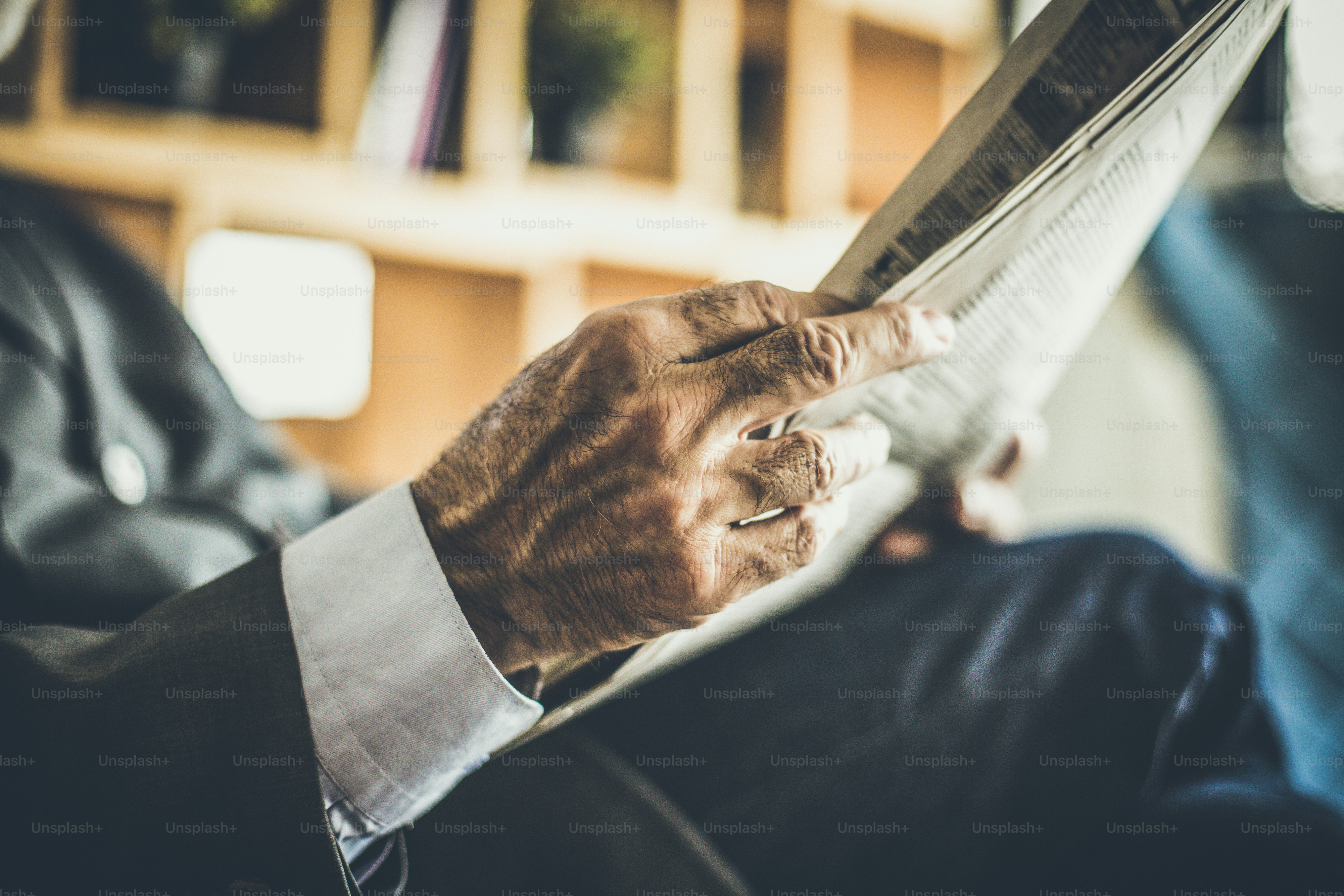 Close up image senior businessman hand with newspapers.