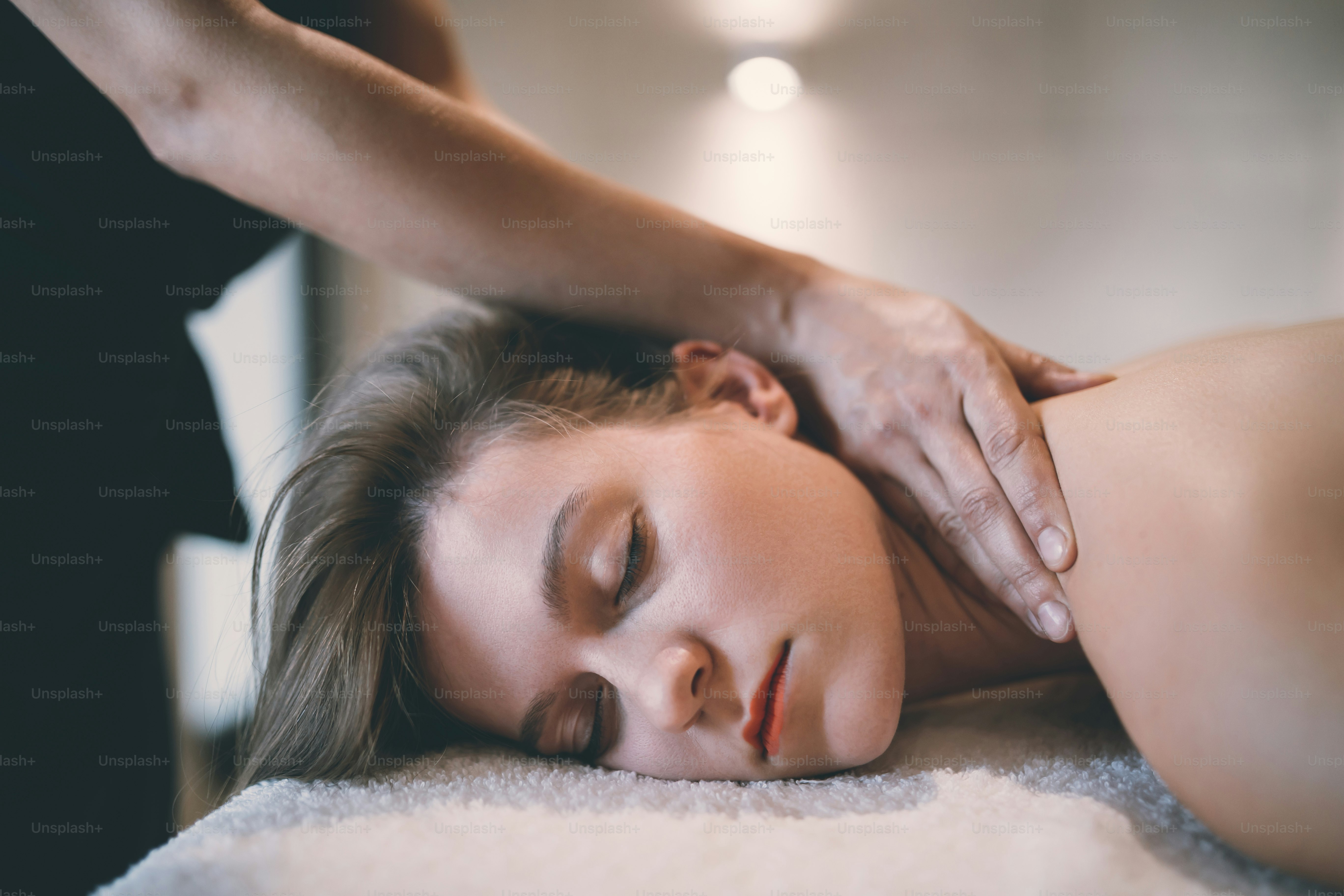 Rejuvenating relaxing massage by masseur at massage saloon