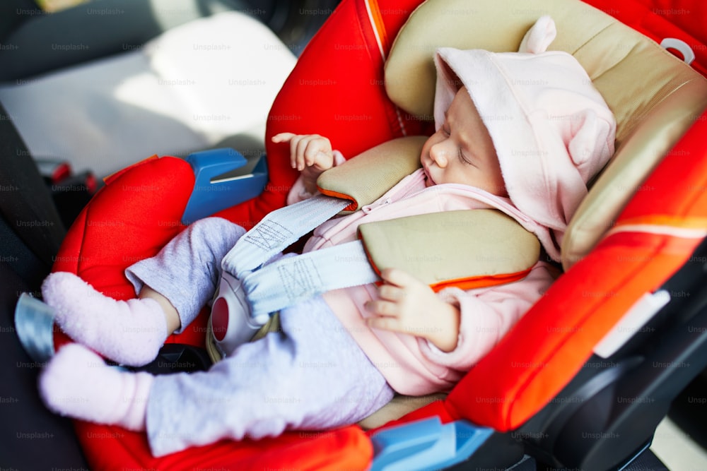 One month baby girl sleeping in car seat