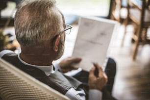 Senior businessman working with papers.