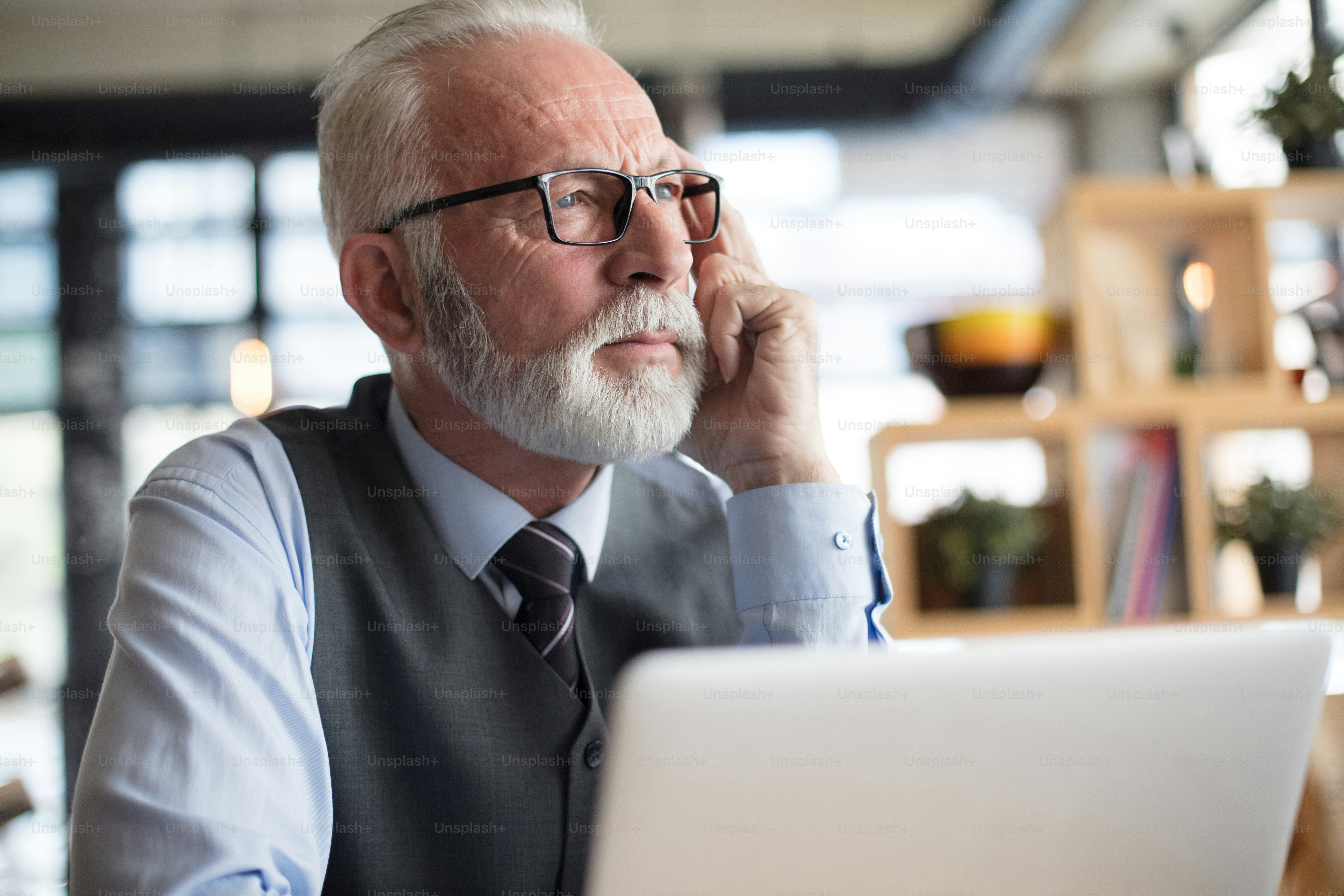 What's next? Senior business man using laptop. Close up.