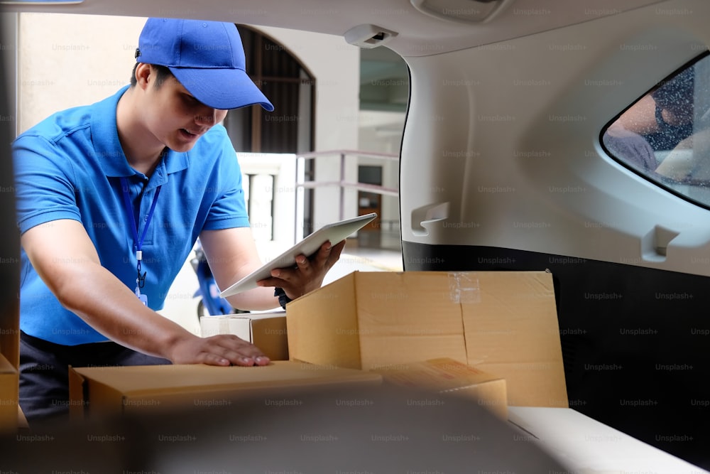 Delivery man working with box in car, Asian man working job.