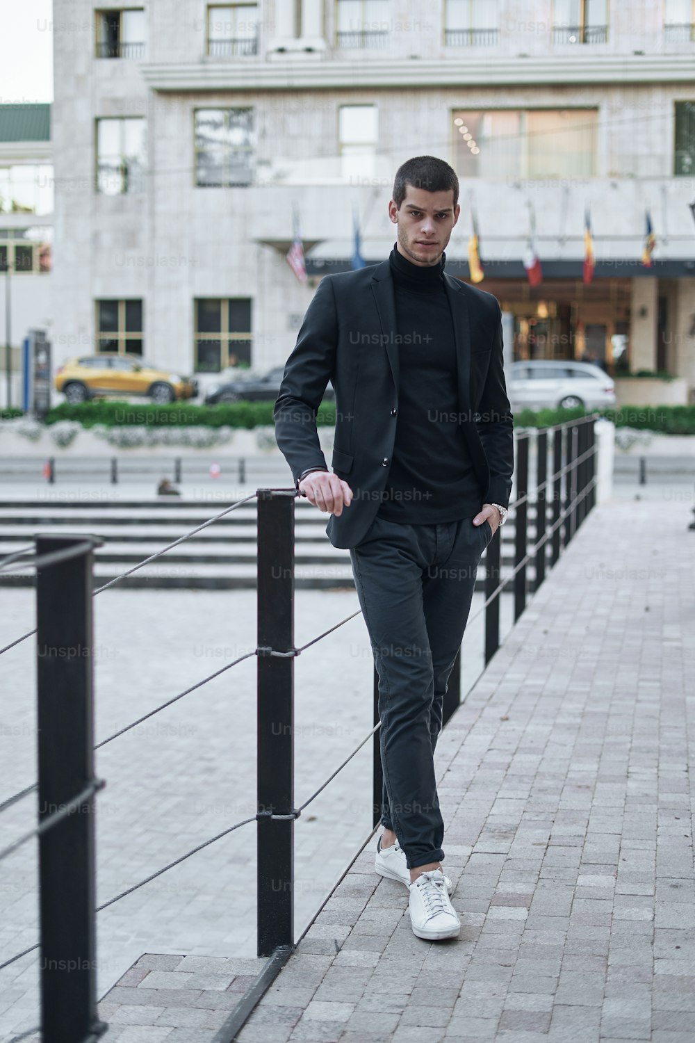Young man walking, smart casual on an autumn day on a street of European City. Lifestyle Photography