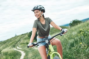 Mountain biking - woman with fatbike enjoys summer vacation