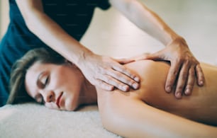 Stress relieving massage treatment by masseur in wellness spa