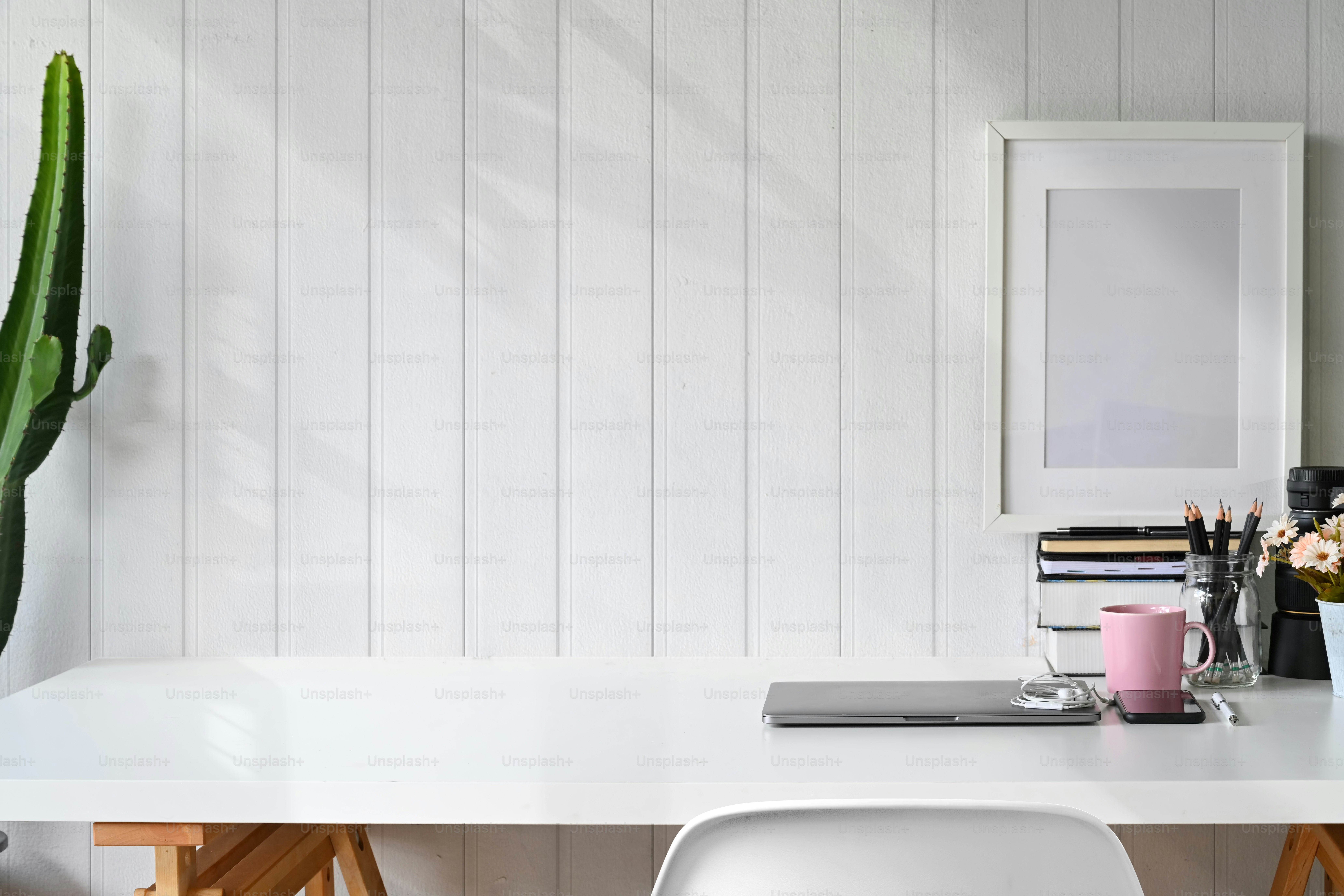 Stylish workspace laptop, poster, home office supplies and copy space