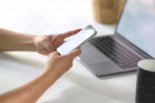 Man using mobile phone on workspace desk.