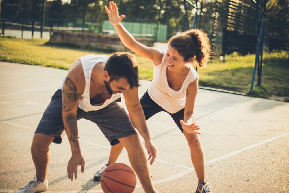 Fun. Couple playing basketball.
