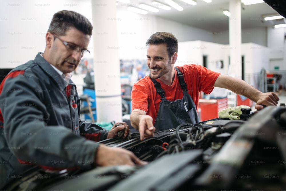 Car mechanics working at automotive service center together