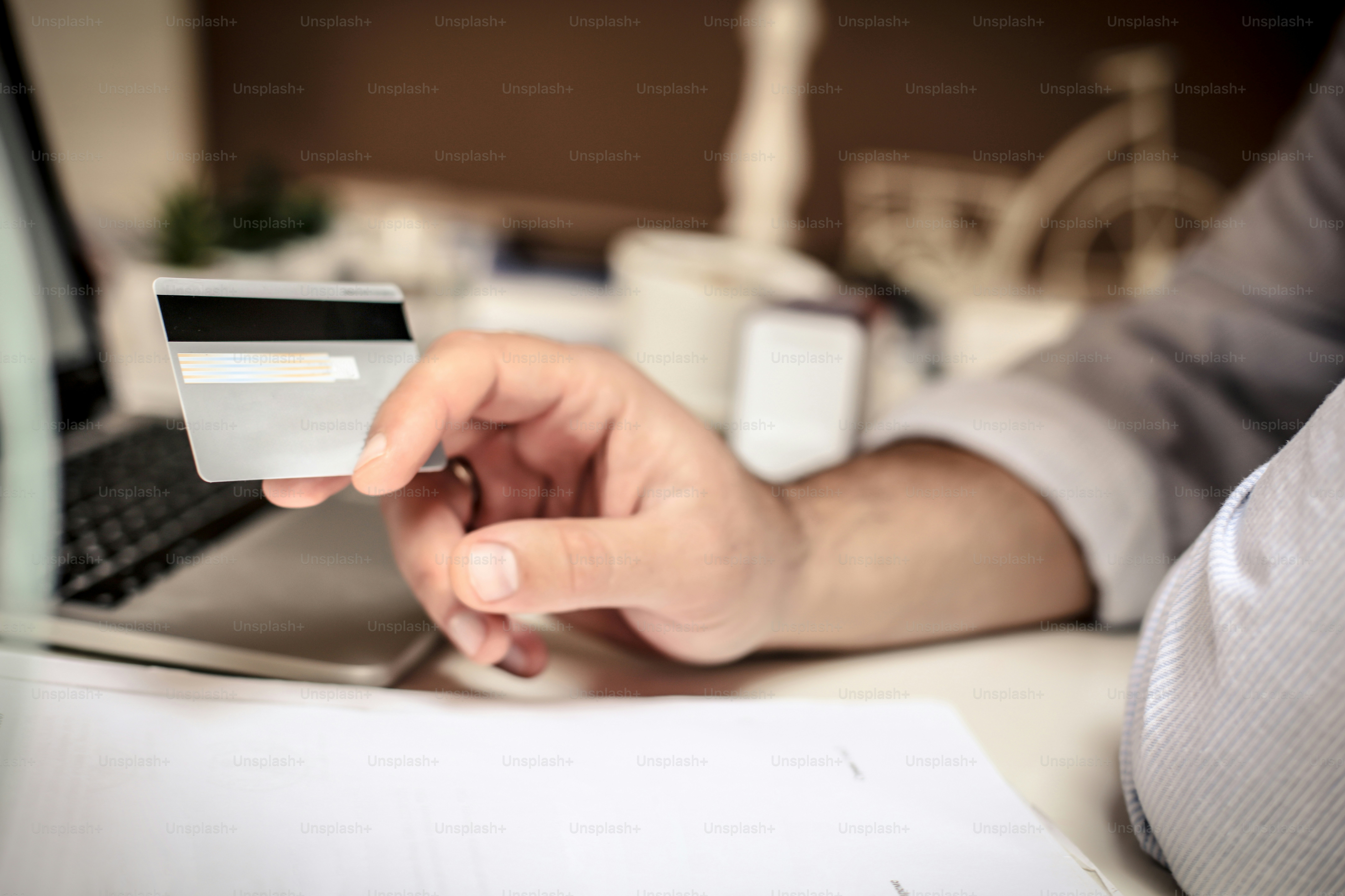 It all goes on the company credit card . Business man holding credit card. Close up. Focus on hand.