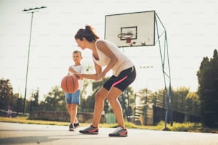 I do not participate in the game anymore. Mother and son playing basketball.