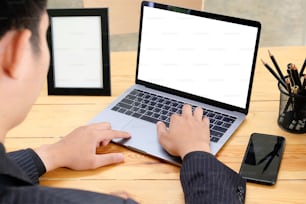 Businessman working with mockup laptop.
