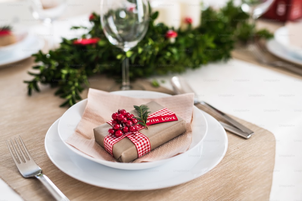 Um close-up de uma mesa posta para um jantar em casa na época do Natal.