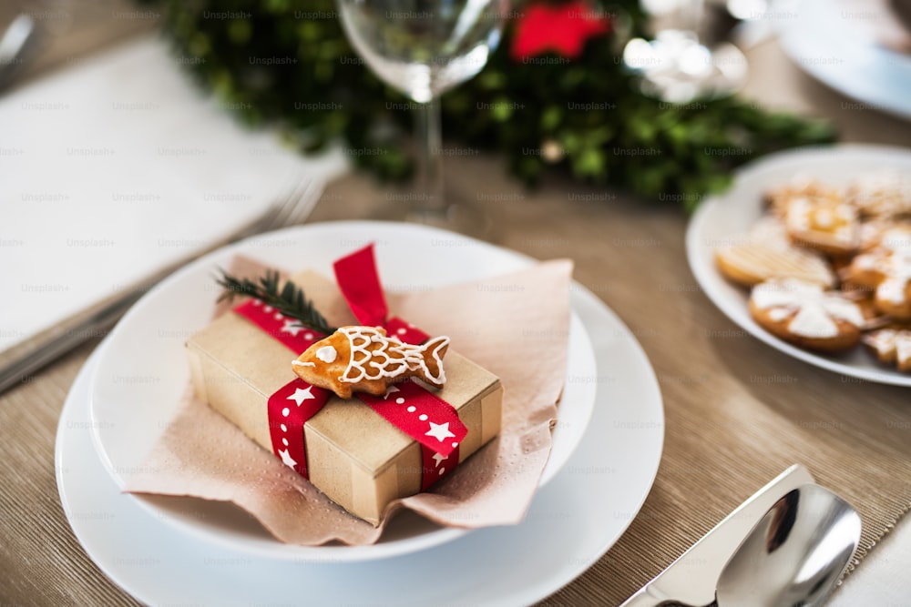 A close-up of a table set for a dinner at home at Christmas time.