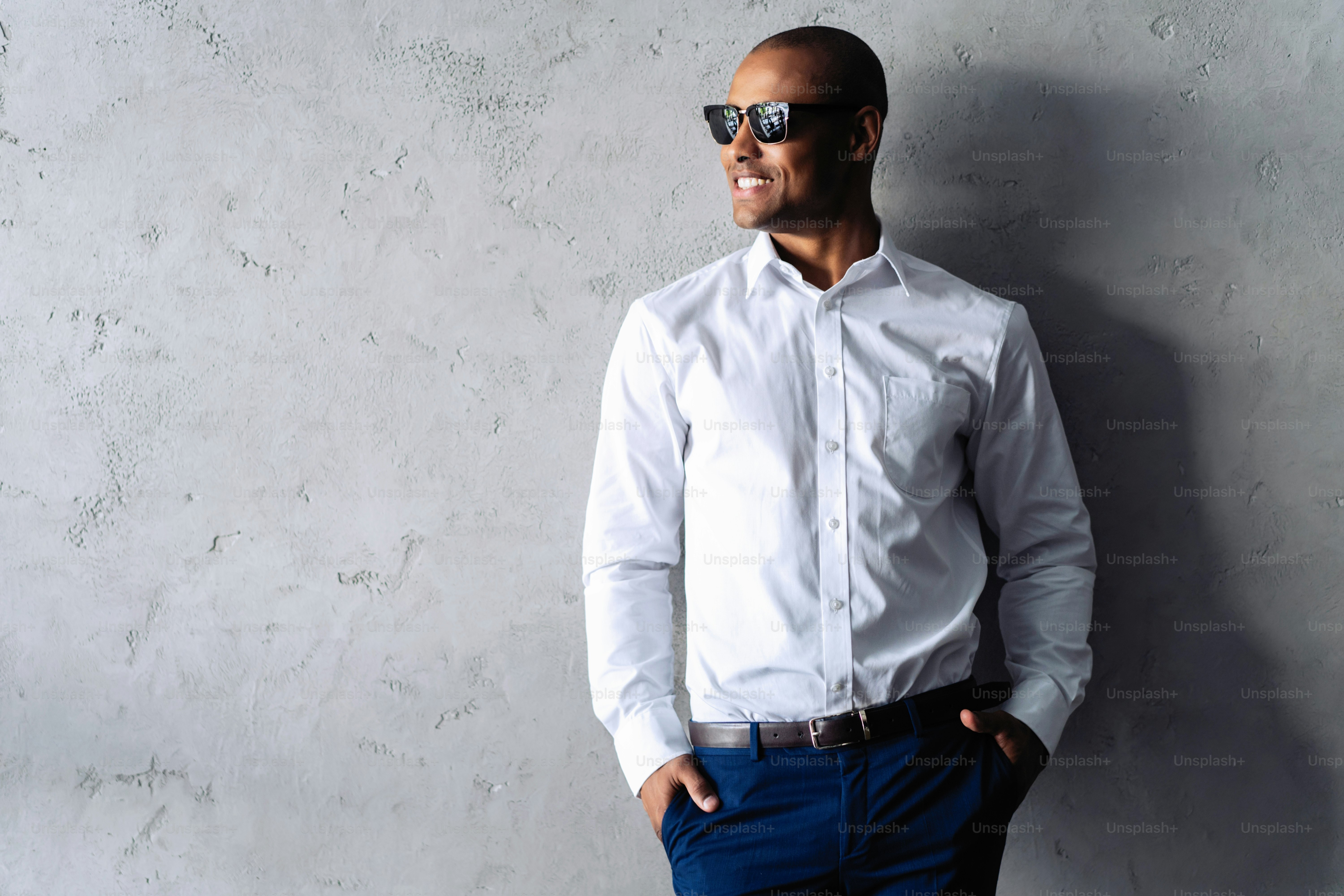 Cool african businessman standing on grey background