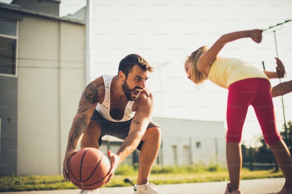 Father daughter time. Father and daughter playing basketball.