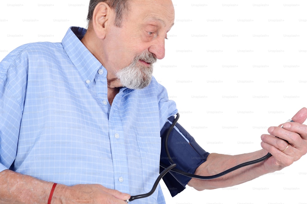 Portraot of eldery man measuring his blood pressure. Medicine concept. Isolated white background