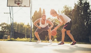 Sabotage. Couple playing basketball.