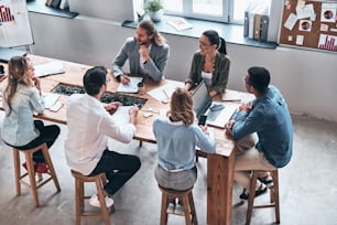 Top view of modern young people discussion business while working in the office