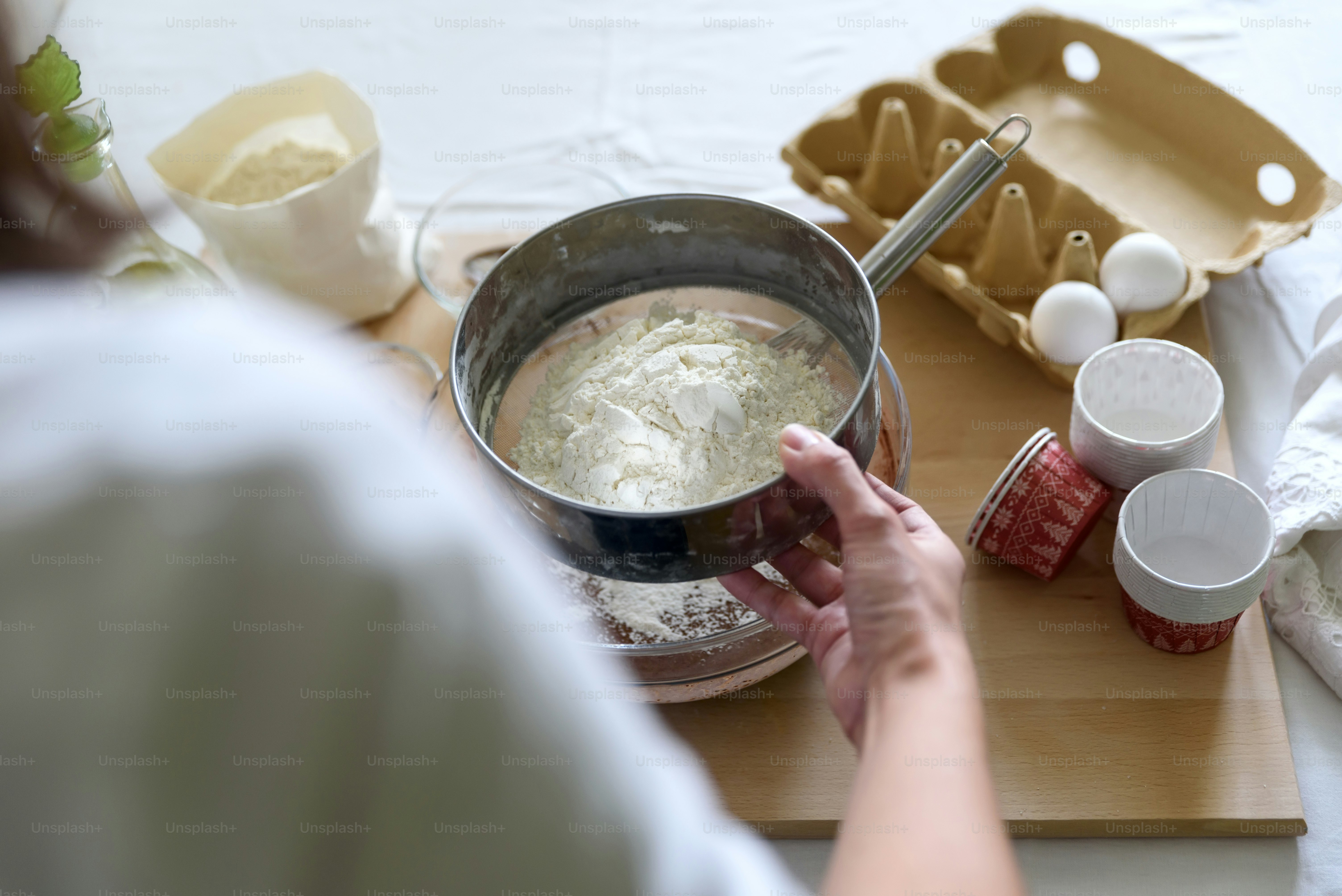 Cooking Christmas chocolate muffins. Mixing ingredients for brownies, cupcakes, pancakes. Woman hands preparing dough for dessert. Selective focus. Back view