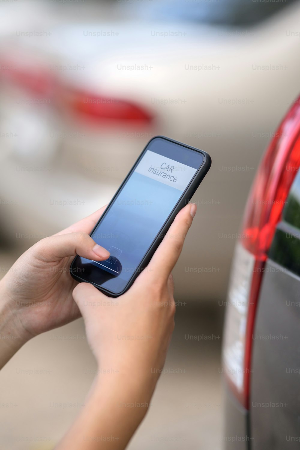 Car insurance concept, Man hand holding car insurance application on mobile phone.