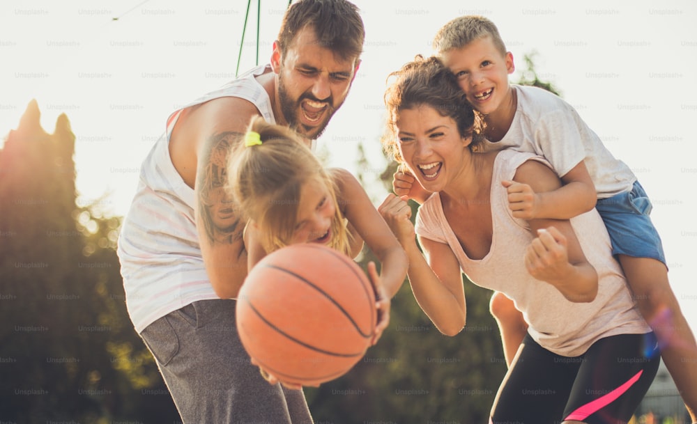 Let your children be happy with you. Family with basketball.