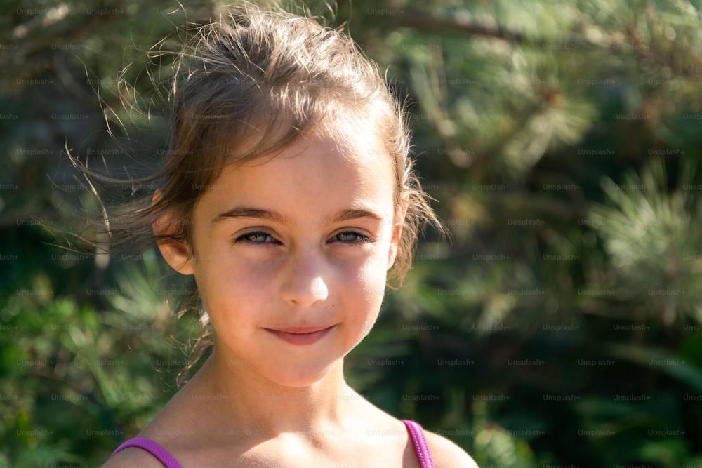 Portrait of a little beautiful girl 5 years old with dark skin and bright blue eyes. Natural children's beauty