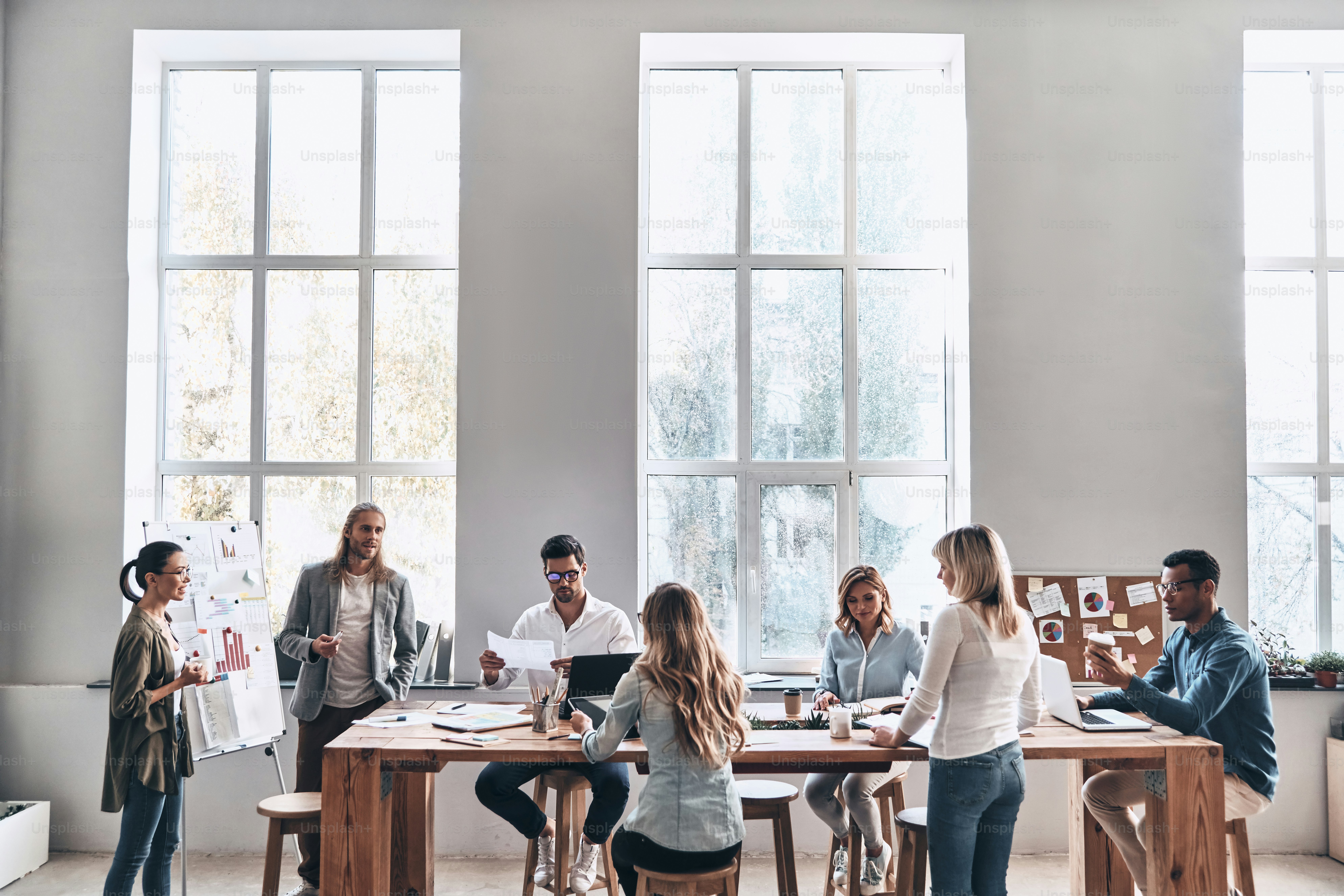 Modern young man and woman conducting a business presentation while working in the office