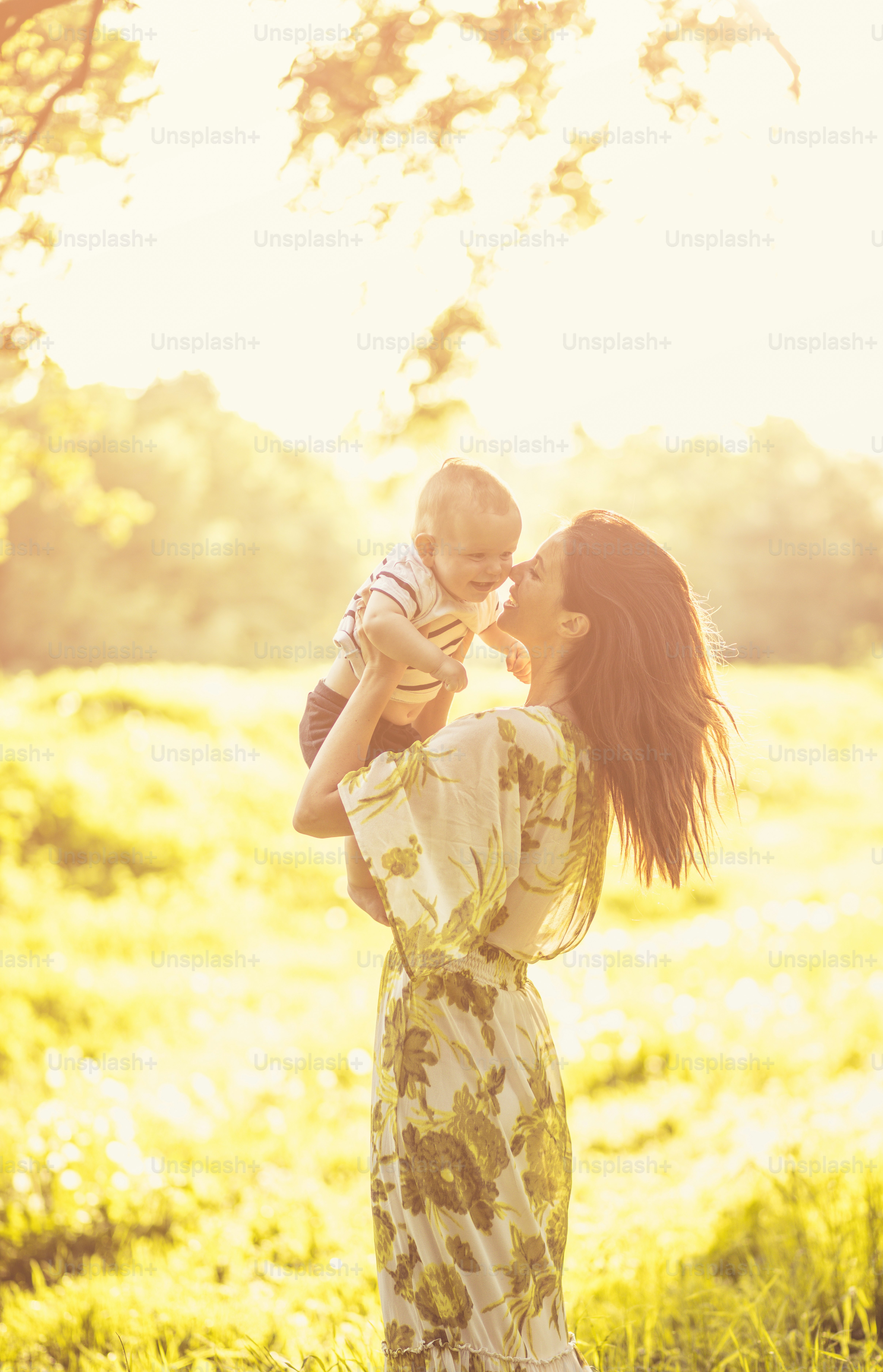 My beautiful dear child. Young mother and her baby enjoy in nature at spring season.