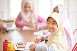 Young Asian Muslim student girls in class.