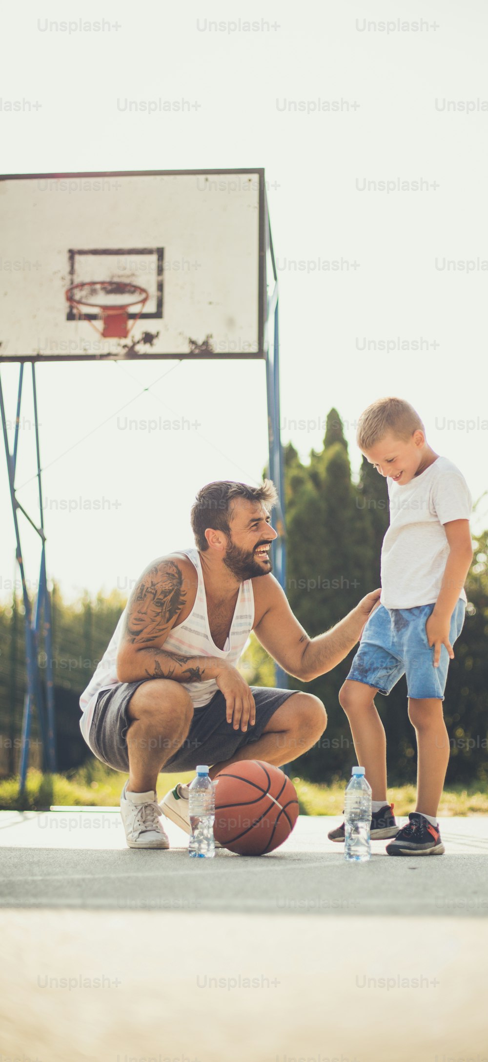 Game for men. Father and son on basket court.