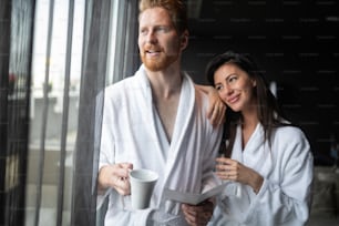 Happy young couple enjoying treatments and relaxing at wellness spa center