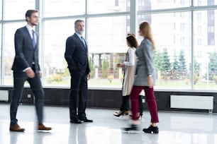 Business people rushing in the lobby. motion blur