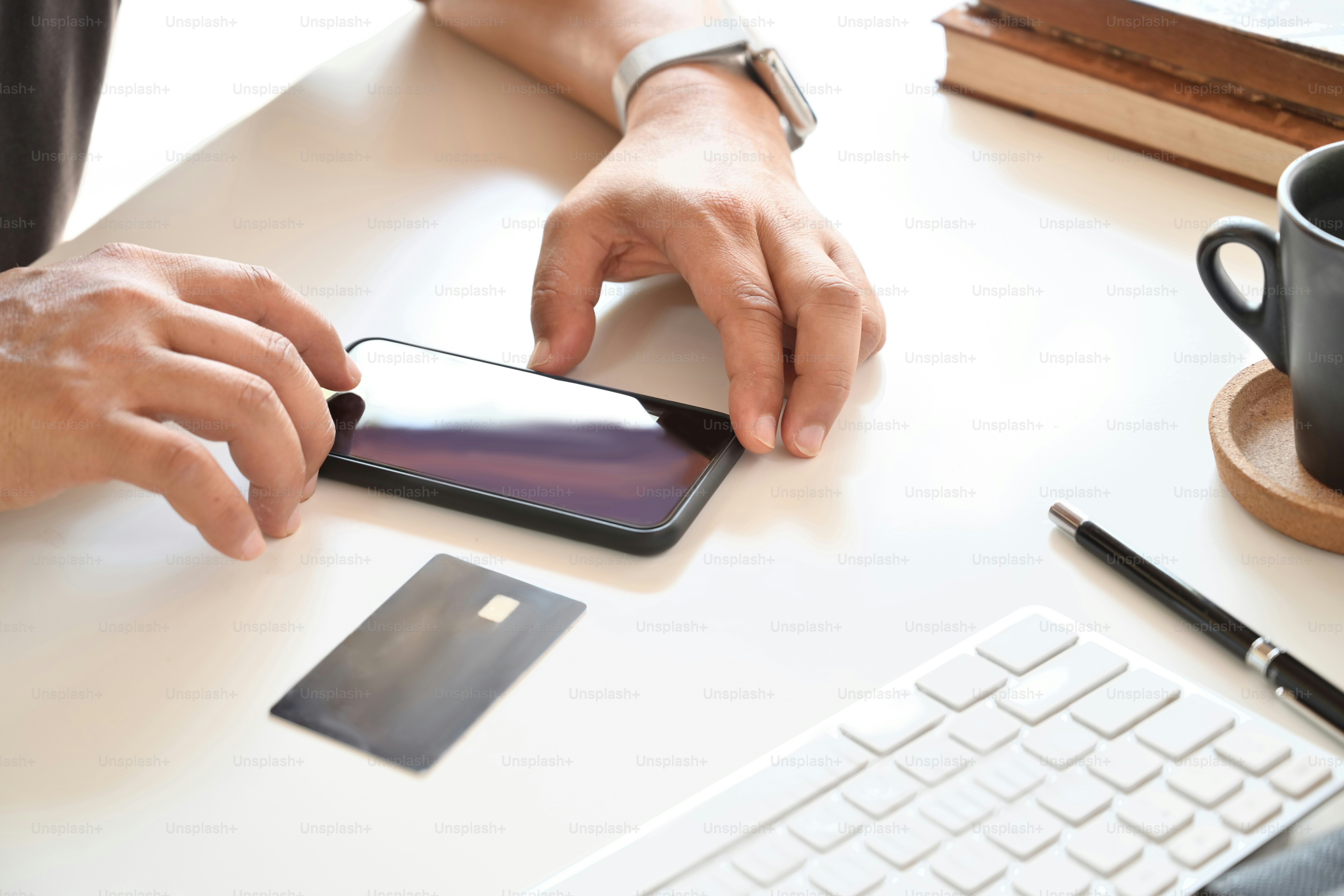 Unrecognizable man using mobile phone and credit card for online payment