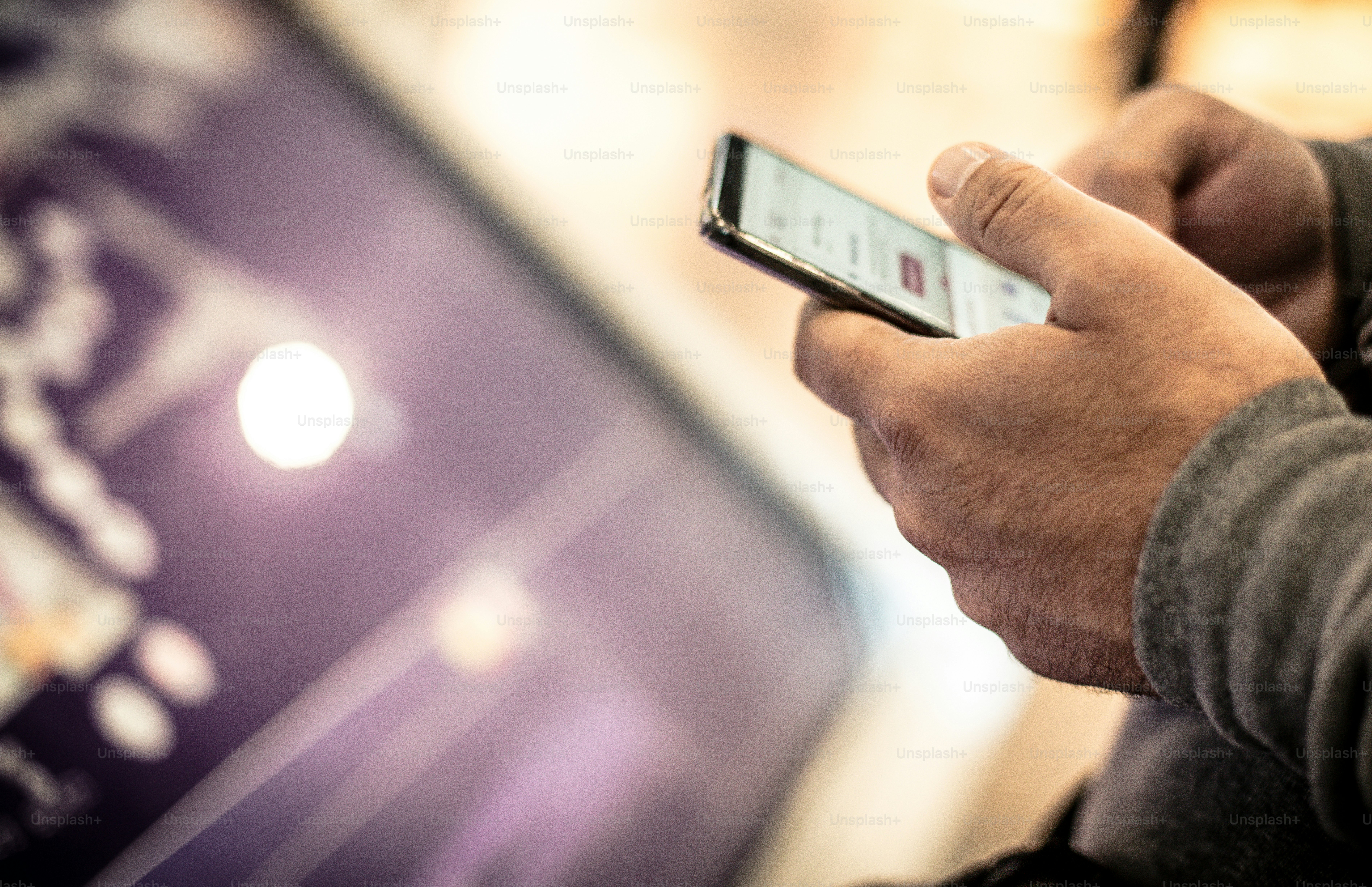 Check your flight on your phone. Man using phone. Close up.