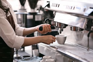 Waitress or Barista using a coffee machine