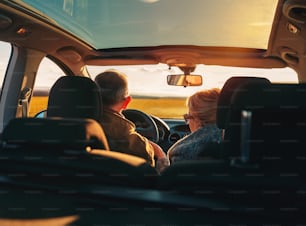 Couple d’aimants âgés voyageant en voiture en vacances.
