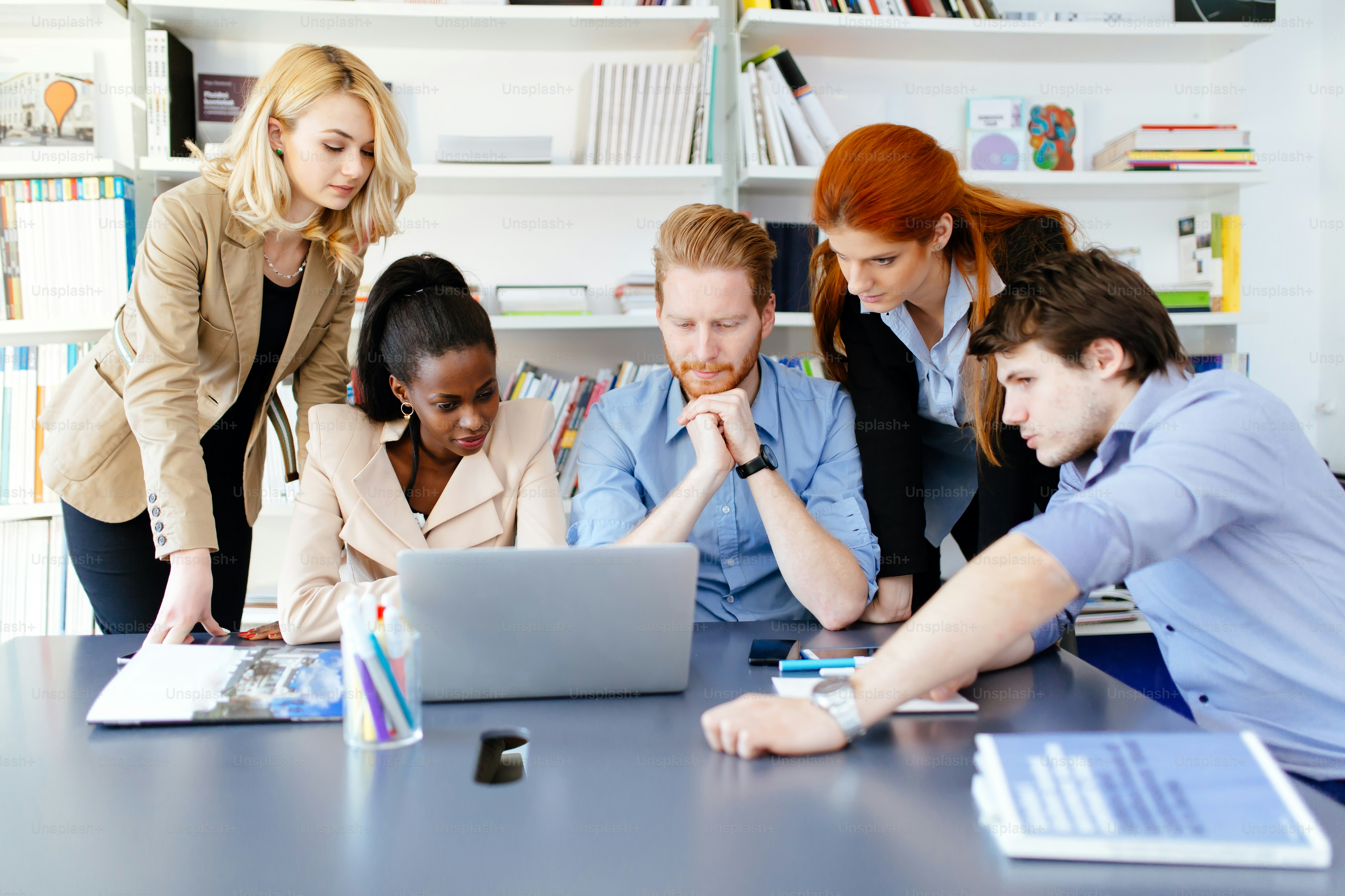 Business people brainstorming in white modern office at desk